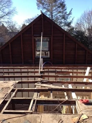 Pressure-treated lumber deck framing with joists and beams during construction phase