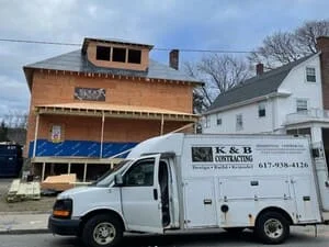 Commercial building renovation with new siding and roofing installation in progress